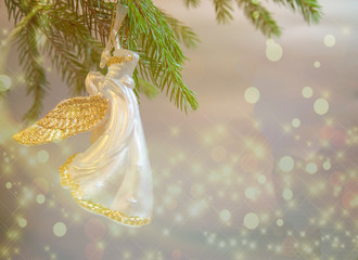 Christmas  trumpet angel toy on Christmas tree branch on white background with lights