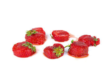 Crushed ripe uncultivated strawberries isolated on a white background