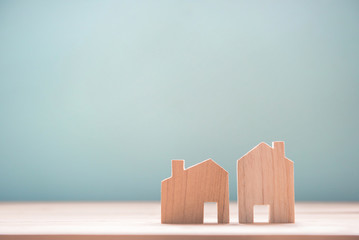 Close up diffirance two wood house model on blue background, Choose home the best for you, Planning...