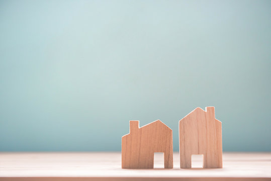 Close up diffirance two wood house model on blue background, Choose home the best for you, Planning to buy property.