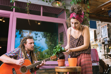 Fond of plants. Dark-haired appealing woman fond of plants feeling amazing while decorating her...