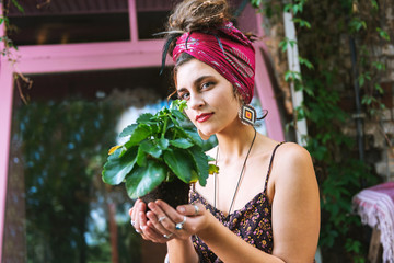 Care of environment. Beautiful blue-eyed woman wearing massive earrings taking care of environment