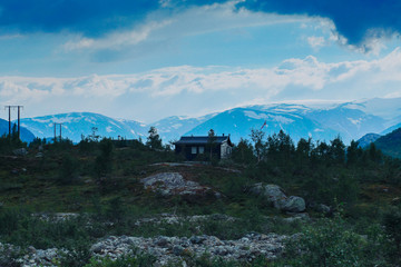 Norway ladscape with wooden house in mountain.