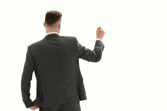 rear view.businessman writing on an invisible Board - Powered by Adobe