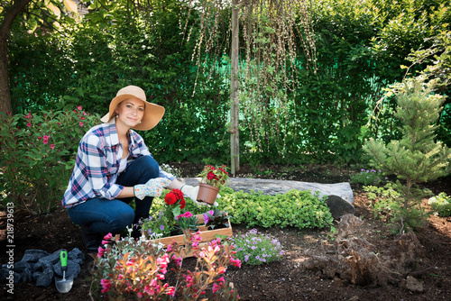 Beautiful Female Gardener Looking At Camera Holding Flowers Ready Beautiful Female Gardener Looking At Camera Holding Flowers Ready To Be Planted In Her Garden