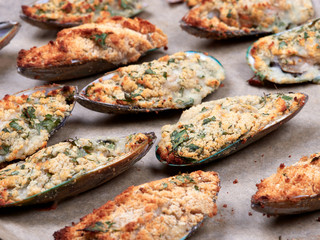 Closeup view of a tray of delicious mussels au gratin, just taken out of the oven