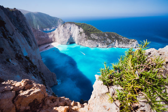 Navagio beach or Shipwreck bay. Turquoise water and pebble white beach in morning light. Famous landmark location on Zakynthos island, Greece