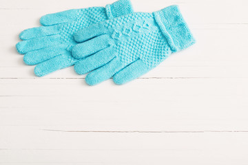 blue gloves on white wooden background
