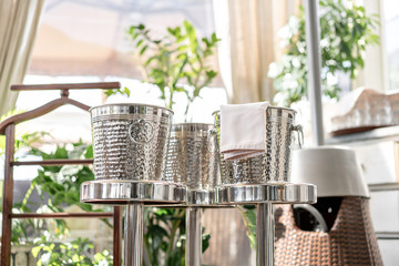 Metal buckets with an ice for cooling drinks. Service area the waiter in restaurant. silver shiny container. Catering set-up ready for the event to begin.