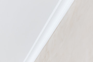Close-up details of interior skirting ceiling of white color, classic style © Parilov