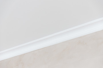 Close-up details of interior skirting ceiling of white color, classic style