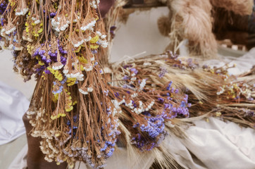 Dried Statice flowers and wheat at countryside at the end of summer season. Seasonal fall harvest background with copyspace.Autumn concept.