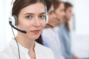 Call center. Beautiful cheerful smiling operator consulting clients with headset. Business concept of customer service