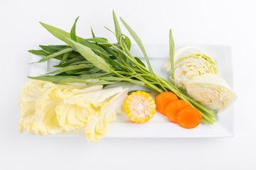 various fresh vegetables for sukiyaki on white dish