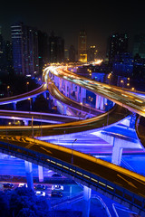 Fototapeta na wymiar View over Neon Blue elevated road system with city background