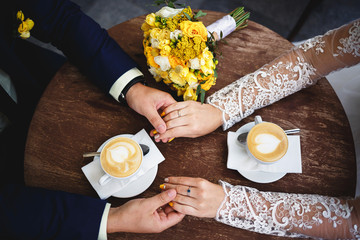 Wedding couple, bride and groom are drinking coffee, having a coffee time. yellow wedding. coffee...