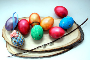 Multicolored eggs, painted for Easter, lie on wooden spits