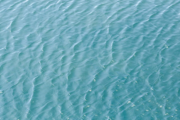 Shining blue wavy water surface ripple background