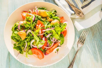 German food - a traditional vegetarian salad with potatoes, tomatoes, onions and arugula