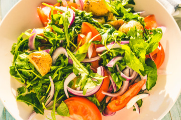 German food - a traditional vegetarian salad with potatoes, tomatoes, onions and arugula