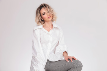 portrait of seductive blonde woman wearing a sexy shirt