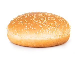 Burger bun with sesame seeds isolated on white background.