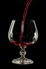 Glass still life image A glass of red wine in a glass on a black background