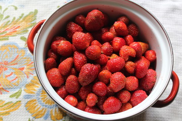 fresh red strawberries in a pot for cooking homemade jam