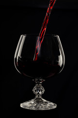 Glass still life image A glass of red wine in a glass on a black background