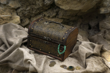 Vintage chest with a treasure deployed from a tissue bundle extracted from old masonry