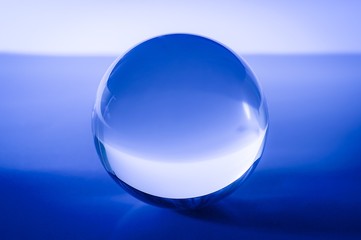 Glass ball in abstract blue