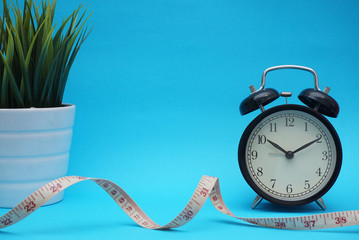 bell clock health concept and measuring tape