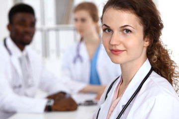 Happy doctor woman  with medical staff at the hospital