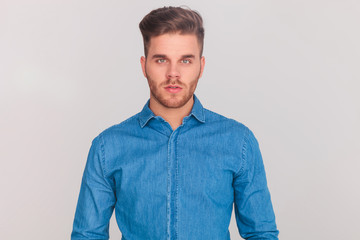 portrait of young casual man wearing a denim blue shirt