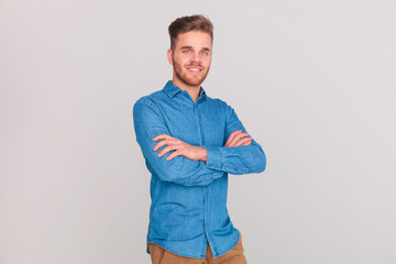 portrait of confident casual man standing with hands folded