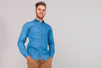 portrait of relaxed casual man in blue shirt standing