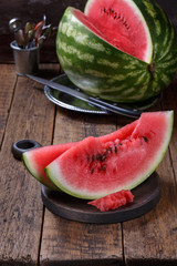 Sliced ripe watermelon on brown wooden table.