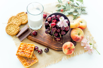 Homemade cinnamon buns in glaze on a dark plate with berries