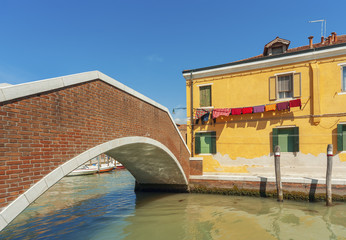 Obraz na płótnie Canvas Colorful house and bridge in Murano island, Venice, Italy.
