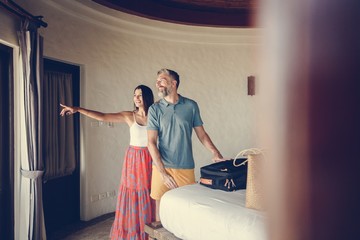 Honeymooners checking in to a hotel room