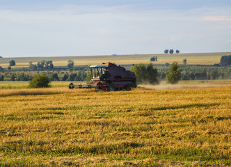 Combine harvester. old combine harvester working on the wheat field Kombain collects on the wheat crop. Agricultural machinery in the field.