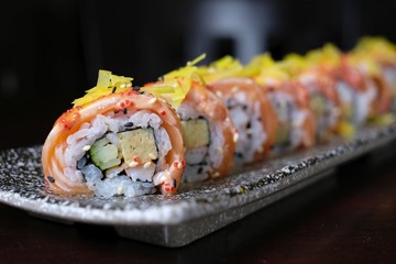 close up salmon sushi roll with spicy sauce - japanese food style