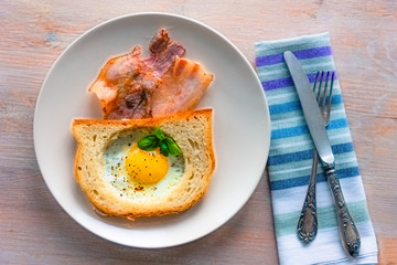 French breakfast - fried egg in toast and bacon