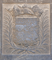 old coat of arms on the wall in the cathedral of Beziers