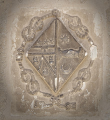 the old coat of arms on the wall in the cathedral of Beziers