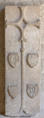 old coat of arms on the wall in the cathedral of Beziers