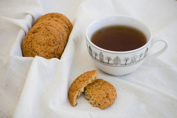 Homemade oatmeal cookies with raisins. Healthy biscuits. Morning cup of tea with oatmeal cookies.