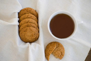 Homemade oatmeal cookies with raisins. Healthy biscuits. Morning cup of tea with oatmeal cookies.