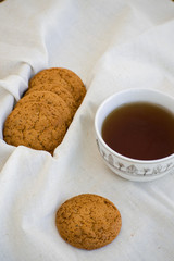 Homemade oatmeal cookies with raisins. Healthy biscuits. Morning cup of tea with oatmeal cookies.