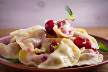 Dumplings with cherries. Pierogi, varenyky, vareniki, pyrohy - dumplings with berry filling. horizontal